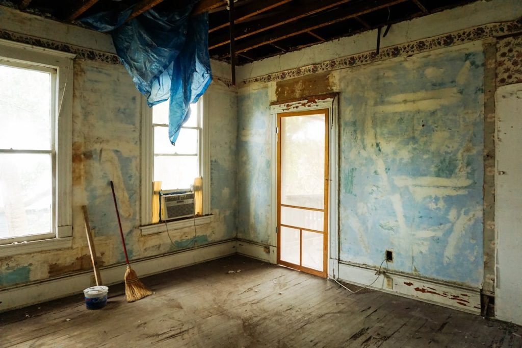 Mastering the First Impression: Your intriguing post title goes here An empty room in an abandoned house with peeling walls and construction tools.